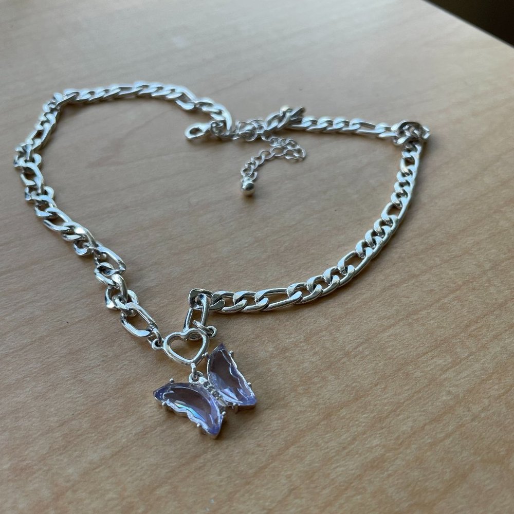 Silver chain necklace with purple crystle butterfly pendant.